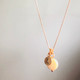 shown with a gold tiny initial tag