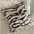 The Serengeti pillow has a modern zebra pattern  in printed velvet in shades of silver with black and white. 