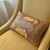 Casbah Lumbar  pillow mocha has paisley print in golden yellow and spruce green on brown background.