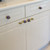 White Kitchen cabinetry with Nu iris knobs 1.5 in diameter with Eel Iris pulls 4 in. 