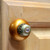 Nu duchess knob deep gold against light stained cherry cabinetry