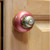 Nu duchess knob coral against light stained cherry wood cabinetry. 