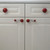 Mini style 6 knobs with matching eel style 6 pulls on white cabinetry