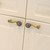 Horizontal placement of Iris Eel pulls on white kitchen cabinetry