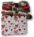 Send a sweet embrace with this hug-able plush and assortment of chocolates and cookies.