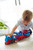 Eco-friendly Green Toys Train set in play, fostering creative play and motor skills development.
