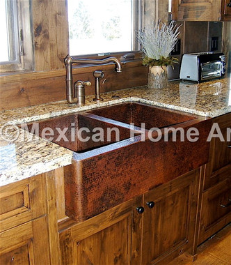 Double well copper farmhouse sink in somber patina undermount install into granite counter top