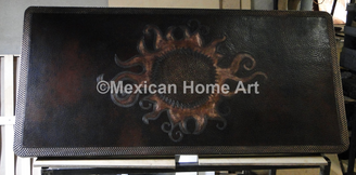 Antique patina Blazing Sun Motif on Somber patina backdrop copper table top rounded corners close up
