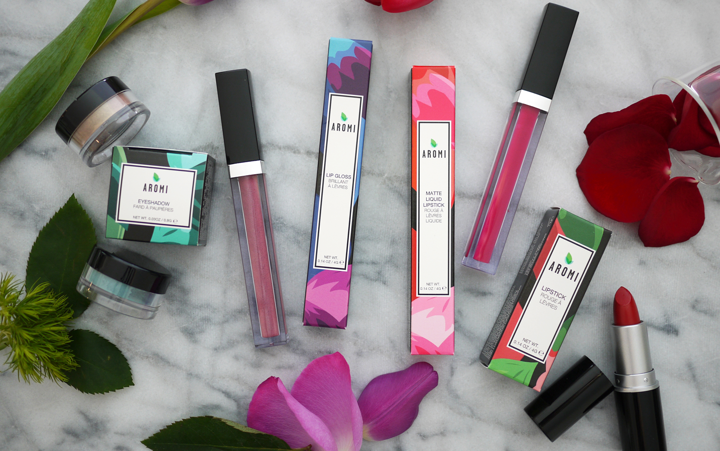 Aromi Beauty cosmetics photo featuring our handmade liquid lipstick, lipstick, lip gloss, and eyeshadow.