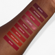 Aromi red liquid lipstick swatches on darker skin