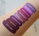 Aromi purple liquid lipstick swatches on light skin