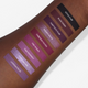 purple and plum liquid lipstick swatches on dark skin