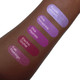 Aromi pink and lilac lipstick swatches on darker skin