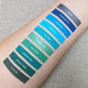 blue and green lipstick swatches on light skin