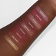 Aromi liquid lipsticks swatched on dark skin