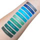 blue and green swatches on light skin