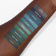 blue and green swatches on dark skin