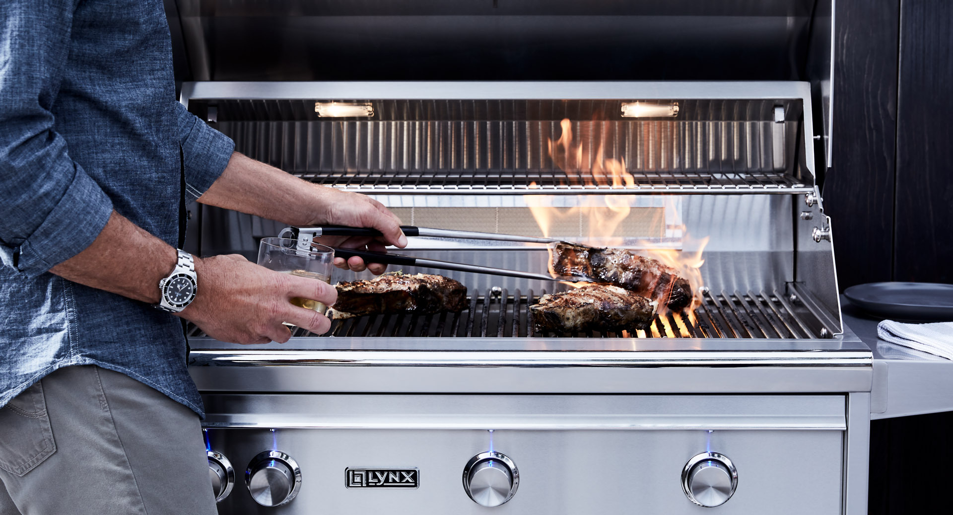 Man flipping steak on grill