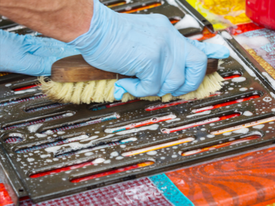 cleaning grill grates with a brush
