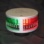 A black background with silver circular light. Green glowing lights on left and red glowing lights on right