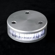 a black background with a round silver light base. Has a bright white light on center. Horizontally