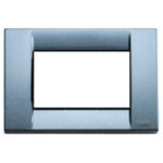 A shiny light grey blue Classica cover plate. Square. sharp corners. Hollow center. On a white background