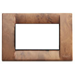 A brown cover plate. Square with swirls. A white square center. on a white background