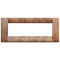 A thin rectangle cover plate in a light cherry wood color. No center. Hallow. On a white background.