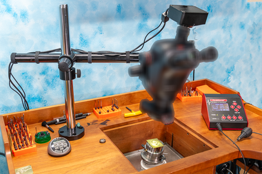 Microscope with C-Mount mounted on a bench with a Swing Arm Stand, 4K Camera, .63 Objective Lens, LED Light and Polarizer.  The PulseGraver from Engraver.com is also on this bench.