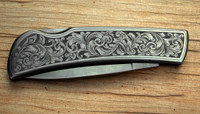 Example of Arnaud's Hand Engraving Design for a Folding Knife (Design 1) engraved on a knife