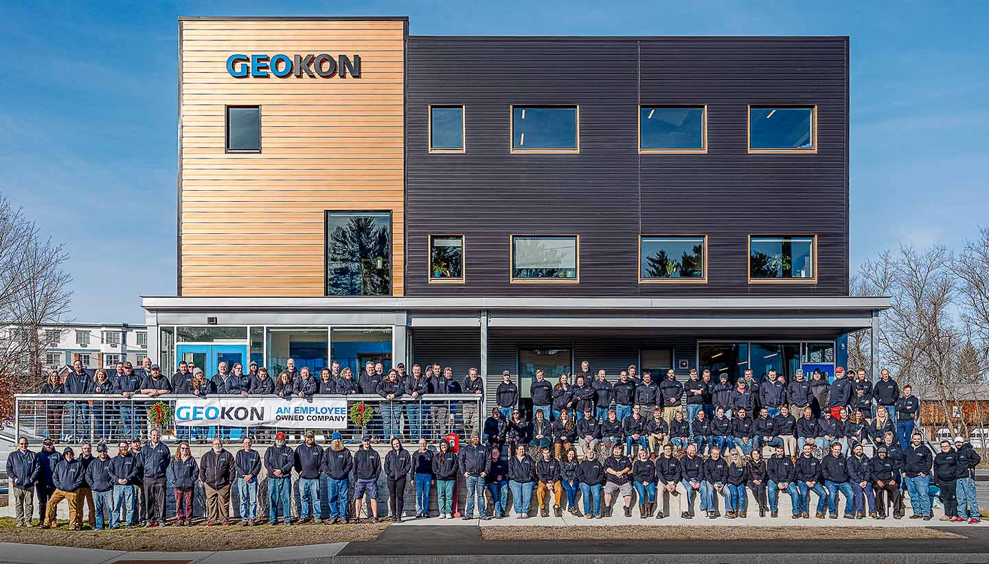 Photo of GEOKON employee-owners in front of the GEOKON North office building.