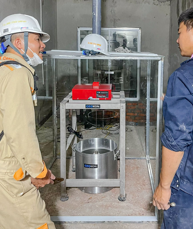 Photo of workers discussing the Model 6850 Pendulum System installation.