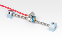 Model 4000 Vibrating Wire Strain Gauge (shown with pluck and read coil, mounting blocks and hose clamp).