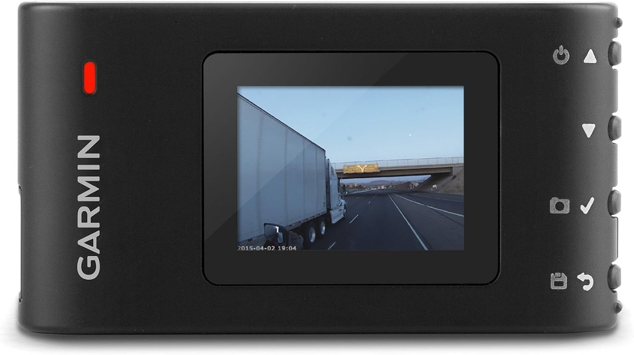 Garmin Dash Cam 30 recording a nighttime drive through illuminated city streets.