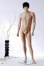 In this full body side view photo, wearing a dark short brunette wig / hairpiece, naked mannequin Alex, stands with his left leg slighly forward along with his left arm while his right remains back - both at about hip level.  Mannequin Alex can be displayed with or without a wig / hairpiece.  Glass stand and support hardware included.