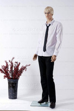 In this full body side view photo, wearing a short blond wig / hairpiece, black slacks, loafers, white long-sleeved shirt with tie, mannequin Alex stands with his left leg slighly forward along with his left arm while his right remains back - both at about hip level.  Mannequin Alex can be displayed with or without a wig / hairpiece.  Glass stand and support hardware included.