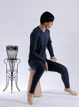 In this full body side view photo, wearing a short dark brunette wig / hairpiece and a tight black workout suit,  mannequin Roger sits upright with his legs apart and his hands in his lap.  Mannequin Roger can be displayed with or without a wig / hairpiece.  Pedestal included.