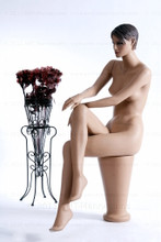 In this full body side view, naked mannequin Ruby sits with her right leg crossed over her left and her right hand resting on her right knee. Her left hand rests on her left knee.   With pierced ears, mannequin Ruby can display earrings and jewelry.  Pedestal included.