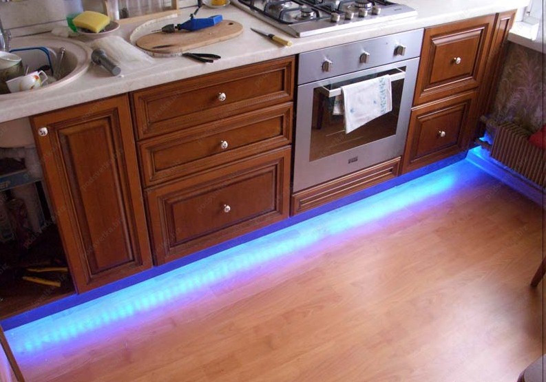 Led strip above store kitchen cabinets