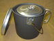 Pot with lid on side--smaller pots nest right into this pot, for easy traveling. Notice the optional bail handle kit, assembled on the larger pot. This lets you handle a hot pot easier, and hang it over your fire, if necessary.