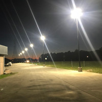 LED Shoebox fixtures and steel light poles illuminating the auto dealership