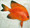 #04072 Emperor Goldfish
12" long in bright orange shades, fading into yellows.  Black accent on fins and tail.  Made of lightweight foam/resin with fins & tail made of natural cornhusk.