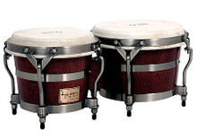 Signature Heritage Series 7 & 8-1/2 inch. Bongos. Tycoon. General Merchandise. Hal Leonard #TBSH800BC S. Published by Hal Leonard.

Tycoon Percussion's Signature Heritage Series Bongos are constructed for the player looking for durability, sound quality and the classic look of banded bongos. Constructed of hand selected Siam Oak Wood, and featuring brushed chrome traditional hoops which are a preference of many professional percussionists. Premium quality 7″ & 8.5″ calfskin heads produce warm, rich bass tones and crisp highs. Their wide tuning range is perfect for live or studio use. Bongo stands and bags are available as an additional option.