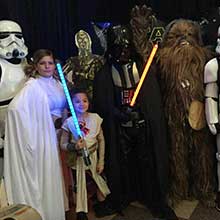customers wearing their star wars costumes. Princess leia, Darth Vader and young Anakin.