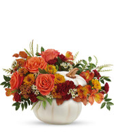 This makes a great piece for your own home or as a gift to someone you love.  A charming white pumpkin holding orange roses and Peruvian lilies, yellow mums, maroon mini carnations, white wax flower and brilliant greens will bring a smile to your face!

