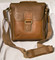 This beautiful leather bag is perfect for work, travel or everyday use.  The adjustable shoulder strap has a leather shoulder pad.  Strap can also be removed and bag can be carried by the padded handle.  Main compartment is covered by a flap that also hides a front slide pocket.  Flap has a magnetic closure.  Full-zip main compartment, fully lined, 1 interior zippered pocket, cell phone pouch with pen loops and a key ring.  Credit card/ID card slots and two additional large slide pockets inside.  Large slide pocket, fully lined, on the back with a zipper closure.  All zippers have leather zip pulls.

Overall Measurements: 11" L x 4" W x 11" H
