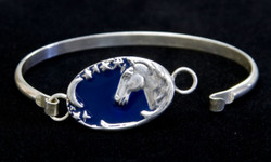 Beautiful Sterling  Silver bracelet features a horse head with a sliver of a moon and a trail of stars.  The dark blue enamel overlay gives depth.  Bracelet measures 2 inches high and 2.5 inches wide.  Also see matching pendant.