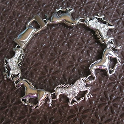 You'll enjoy the sparkle and exciting motion embodied in this running horse bracelet!  Six silver-tone horses will encircle your wrist when you put on this equestrian accessory.  Perfect for any horse-loving person.  Measures approx. 7.5 inches in length.

    Made of Rhodium-plated metal alloy
    Bracelet features an 'easy to use' magnetic clasp
    Each piece is lead-free / nickle-free / hypo-allergenic
    From the Wyo-Horse horse jewelry collection
    Created by jewelry designer Kerstin Stock 