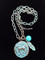 Patina finished Hammered Running Horse Necklace with Turquoise Bead and Feather
This horse medallion measures 1 1/4" tall.
The link chain measures 18" long with a 2" extender
All lead free, nickel free, hypo-allergenic.

Designed exclusively by Kerstin Stock for Wyo-Horse Jewelry