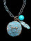 Patina finished Hammered Running Horse Necklace with Turquoise Bead and Feather
This horse medallion measures 1 1/4" tall.
The link chain measures 18" long with a 2" extender
All lead free, nickel free, hypo-allergenic.

Designed exclusively by Kerstin Stock for Wyo-Horse Jewelry